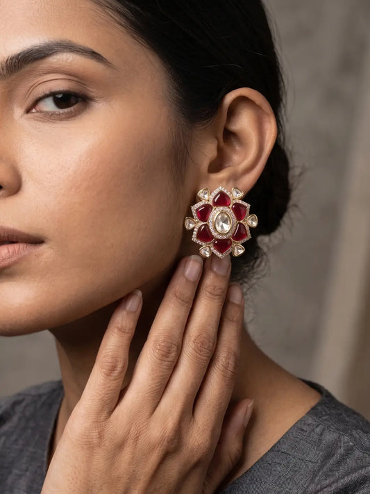 Floral Ruby Kundan earrings featuring rich red stones, luminous white center, sparkling CZ accents and gold plated finish
