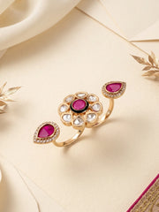 Ruby pink statement ring featuring an open dual-finger design, floral Polki detailing, CZ stones and a gold-plated setting.