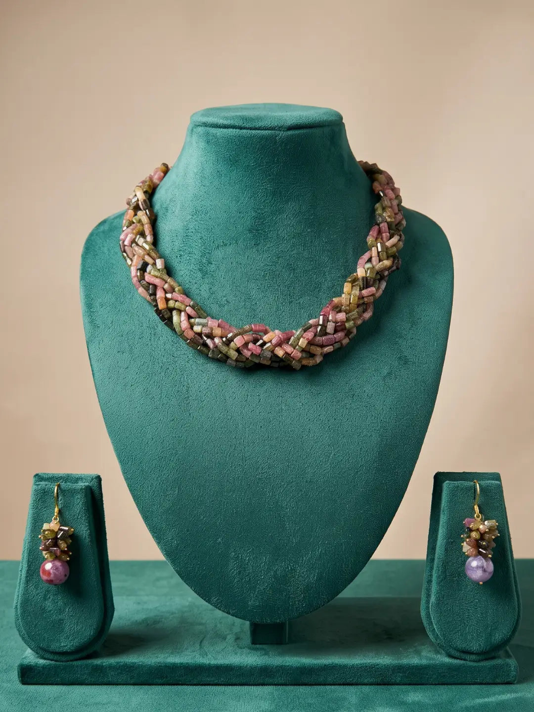 Gold-plated hook-and-eye closure at the back of a multi strand tourmaline beaded necklace, shown beside the layered gemstone strands