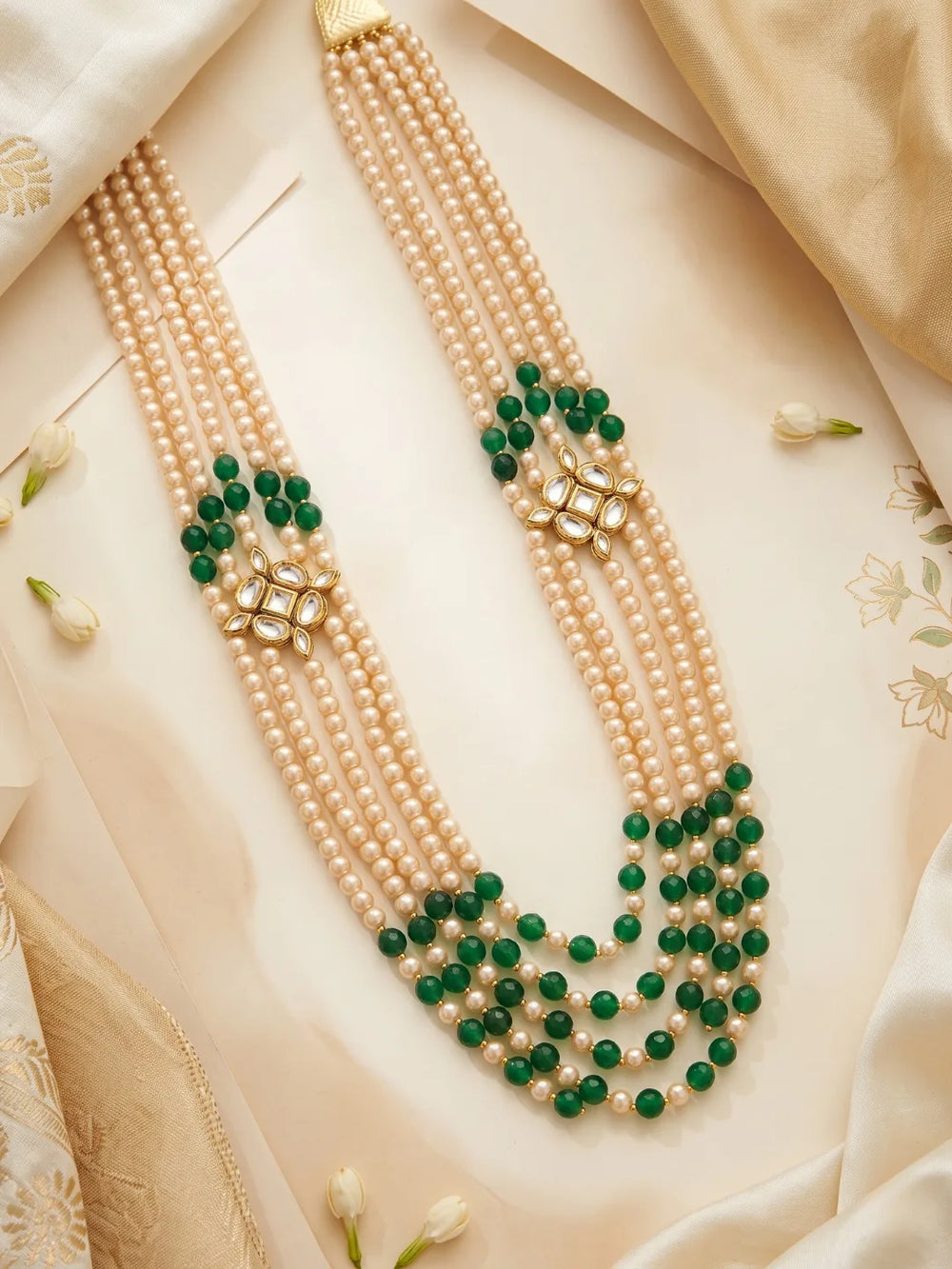 Green groom necklace featuring multiple strands of jade beads and faux pearls, joined by symmetrical gold-plated Kundan-style ornaments.