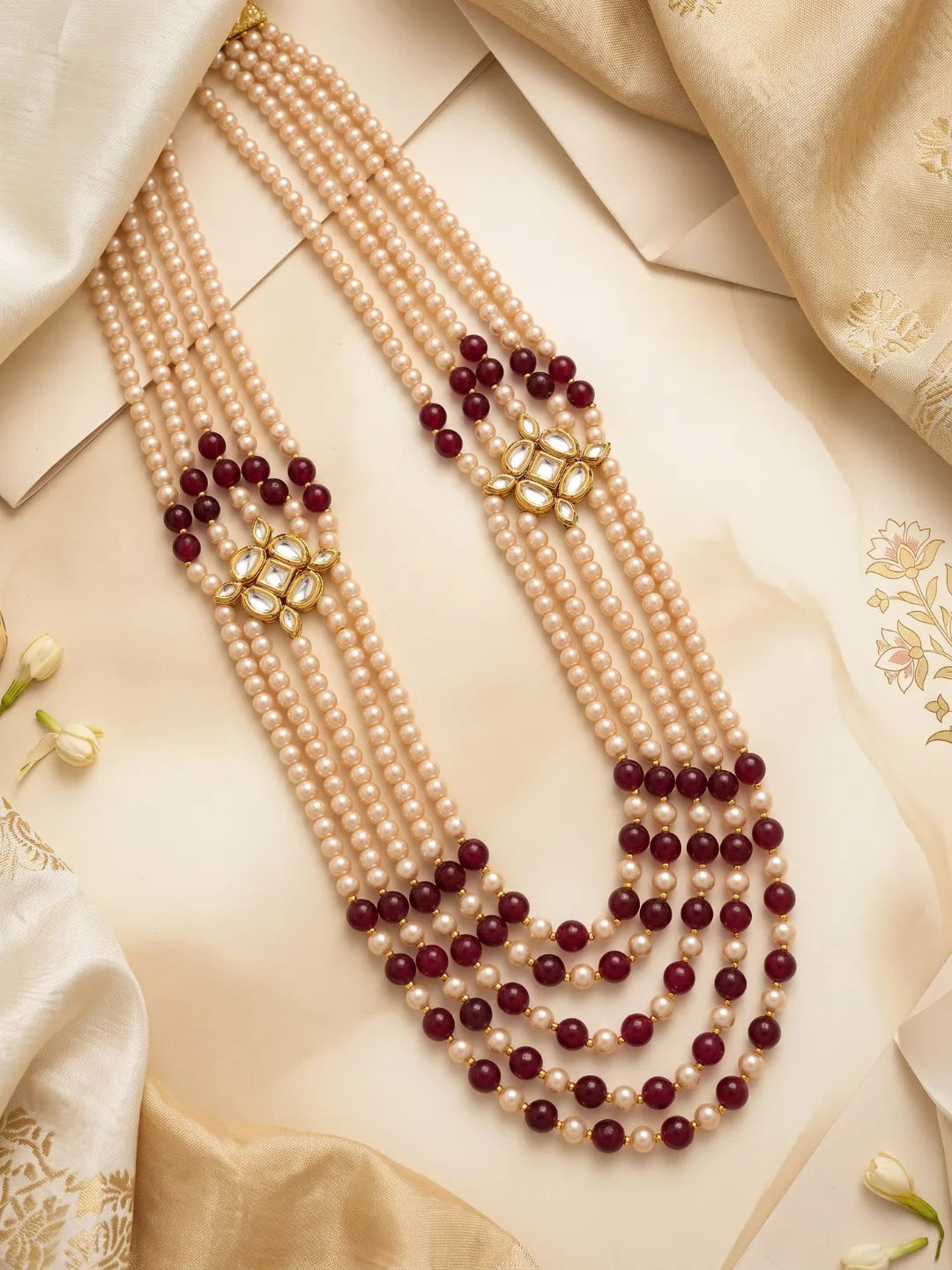 Layered maroon groom necklace featuring jade beads, faux pearls and symmetrical gold-plated Kundan-style side ornaments.