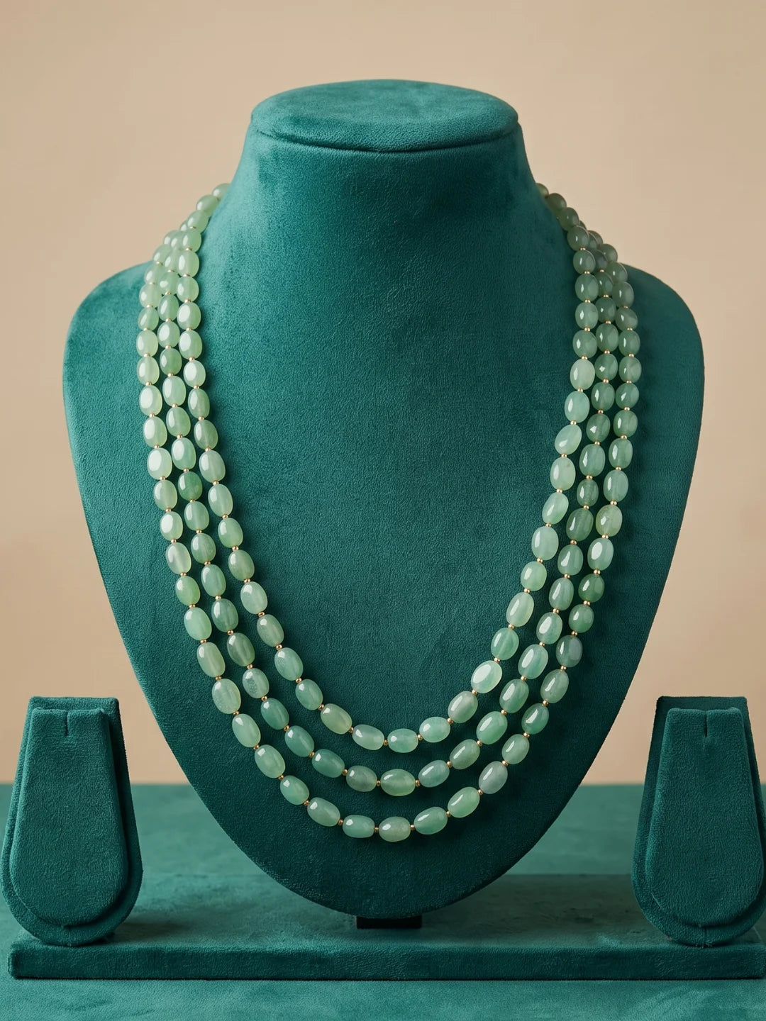 Mint green triple layer dulha mala with polished box-shaped beads and small gold-tone connectors, designed for traditional Indian wedding ensembles.