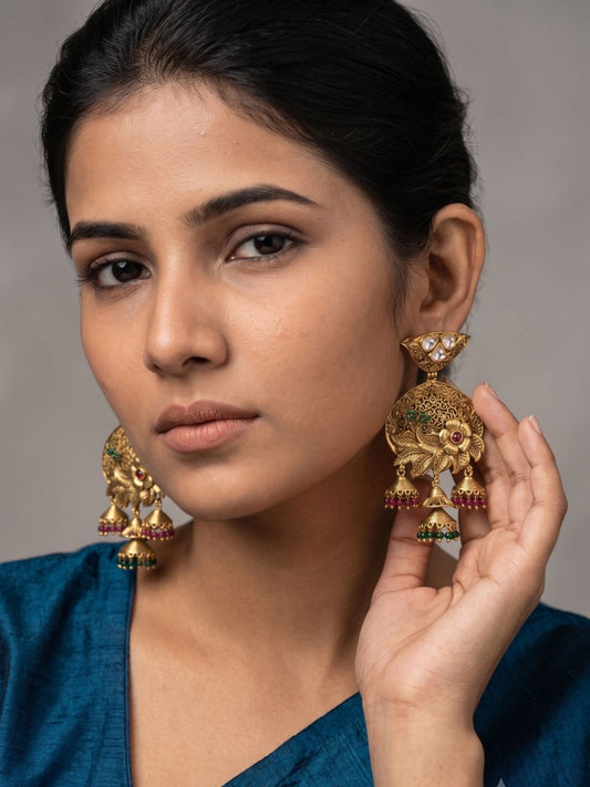 Gold plated antique Kundan Jhumka earrings featuring a floral centre, detailed filigree work and colourful green and ruby bead danglers.