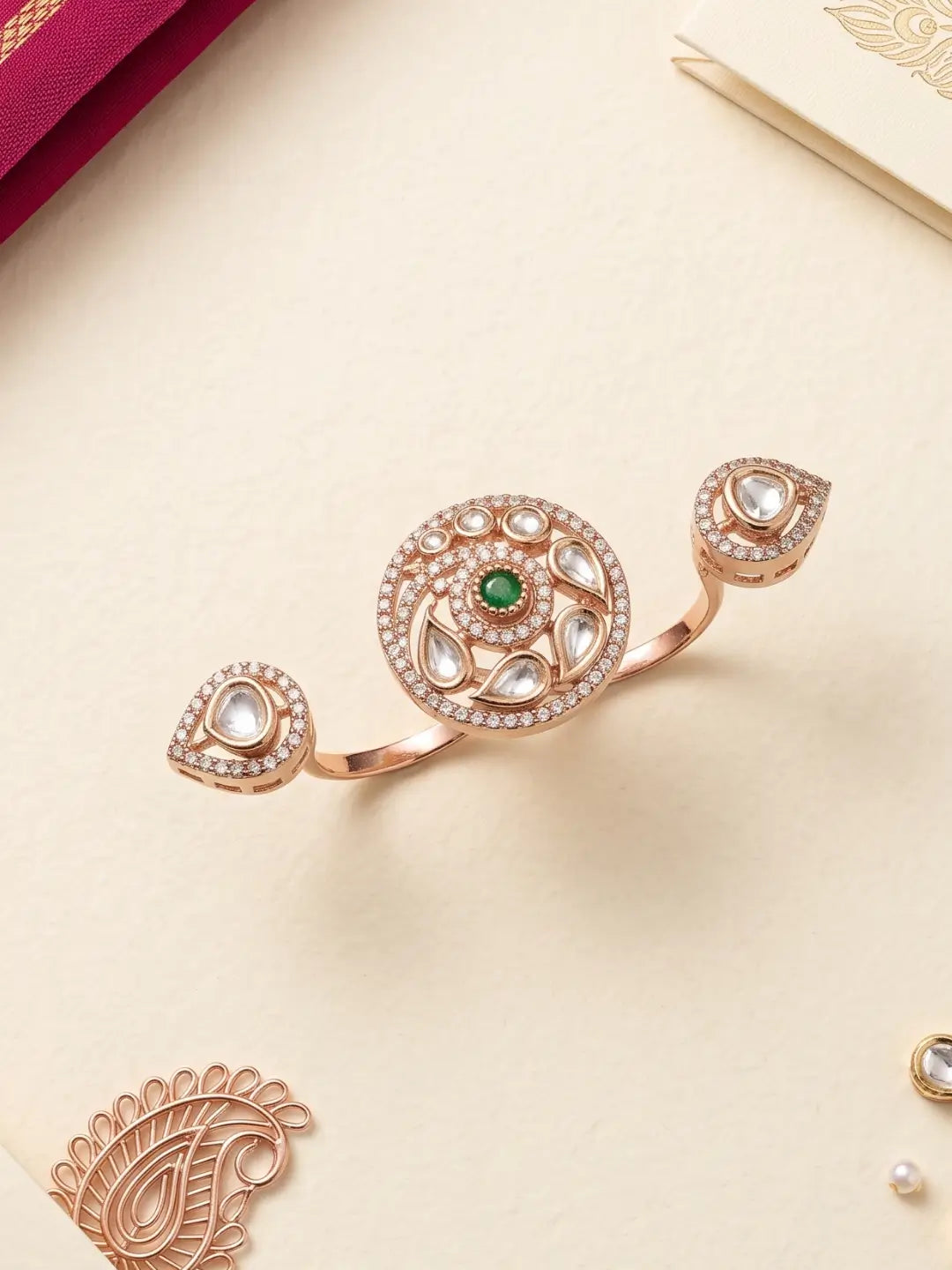 Gold plated green dual finger Polki ring with three connected focal elements, ornate Kundan stonework and floral-inspired detailing for bridal ethnic wear