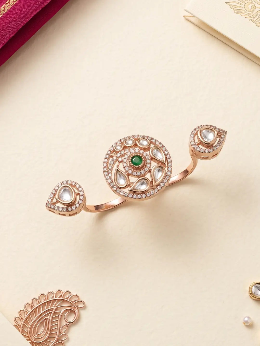 Gold plated green dual finger Polki ring with three connected focal elements, ornate Kundan stonework and floral-inspired detailing for bridal ethnic wear