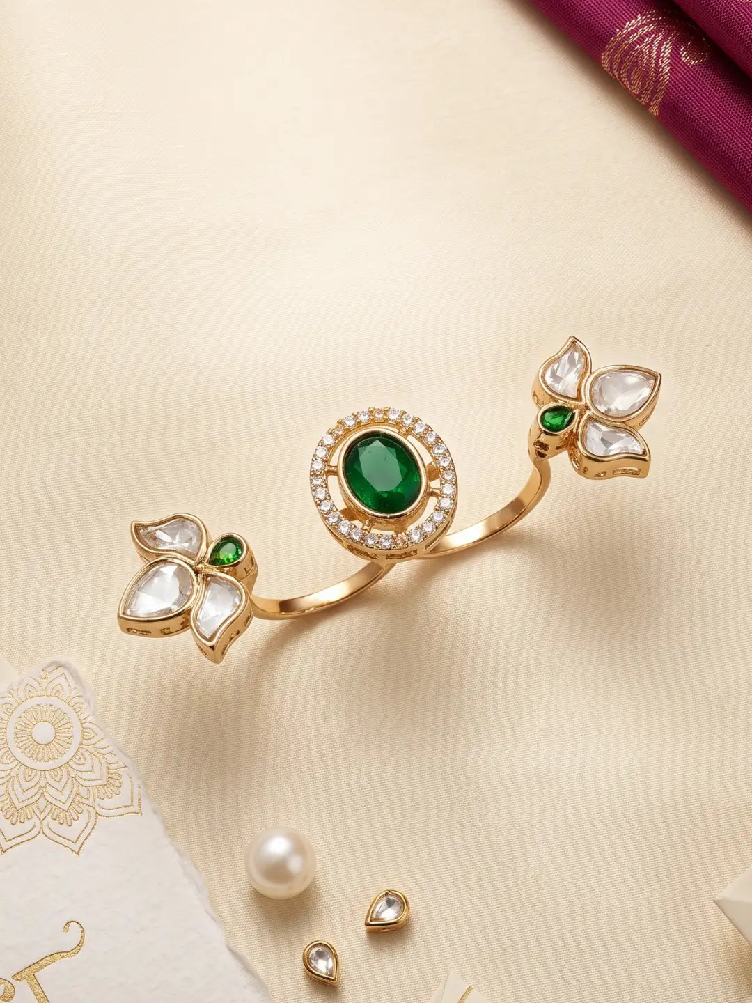 Gold plated green dual finger Polki ring featuring three connected floral clusters, pear-shaped stones and a round centre with CZ accents for weddings