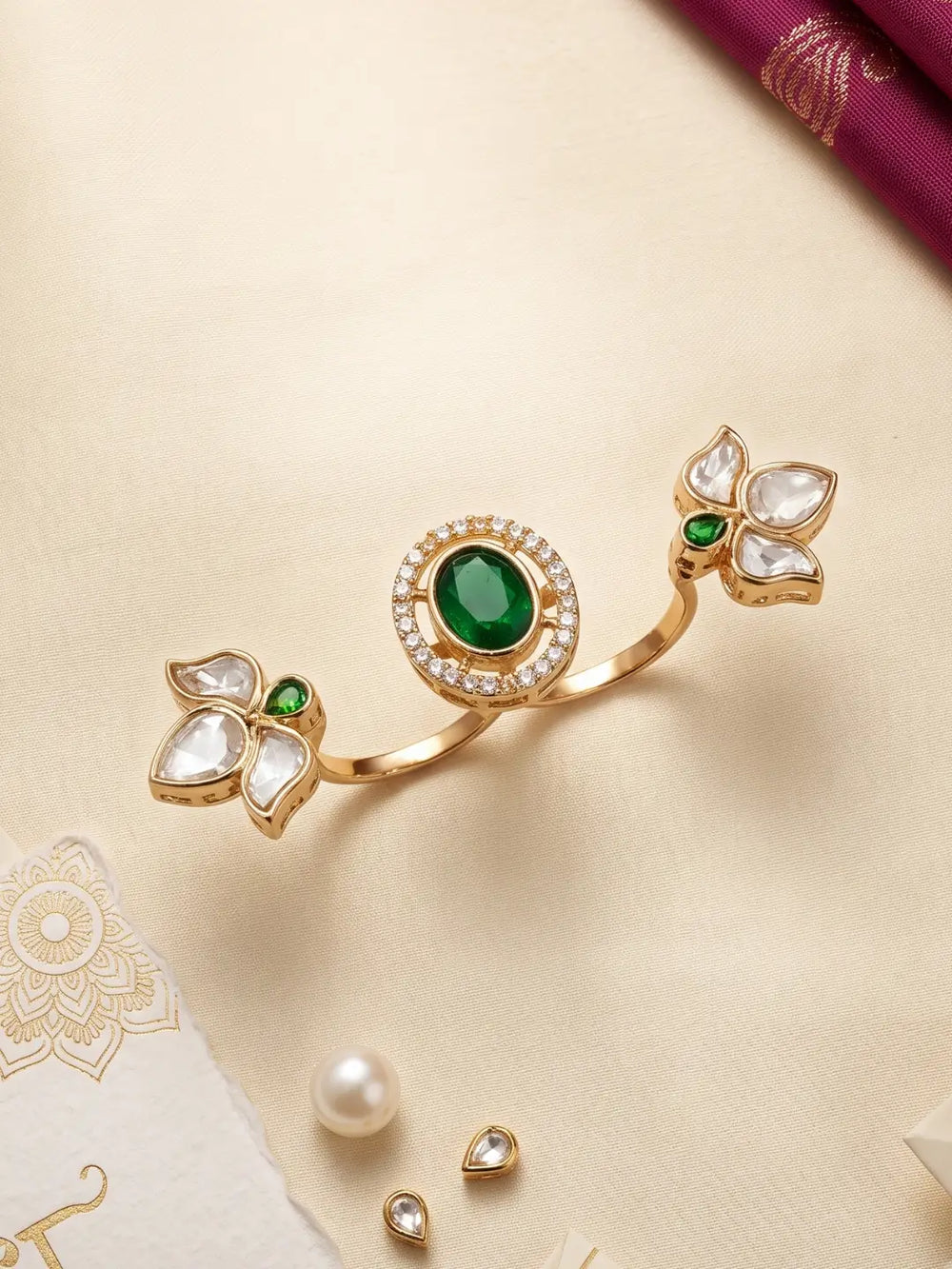 Gold plated green dual finger Polki ring featuring three connected floral clusters, pear-shaped stones and a round centre with CZ accents for weddings