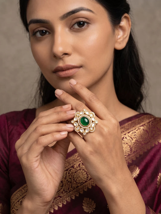 Gold plated green Kundan Polki ring featuring a large oval centre, surrounding Polki stones and floral-inspired detailing for bridal sarees and lehengas