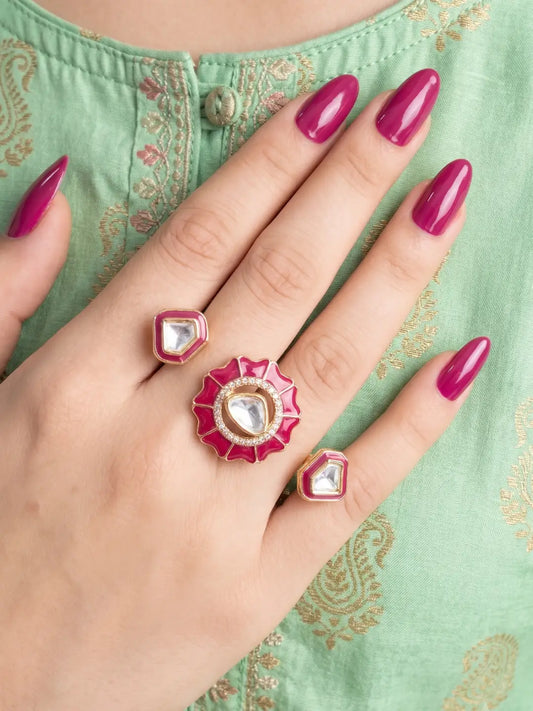 Ruby pink gold plated Kundan double finger ring with enamel and Polki stones, styled as a statement wedding and festive jewelry piece.
