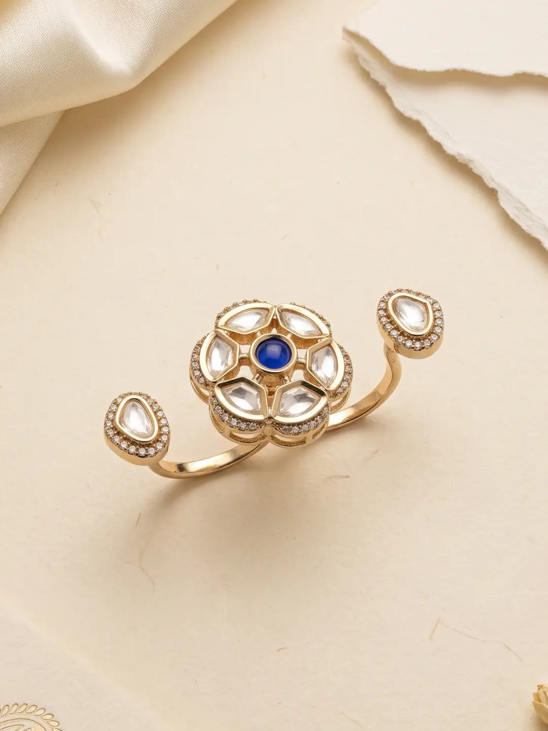 Gold plated navy blue dual finger Polki ring featuring three connected focal elements, ornate Kundan stonework and a statement silhouette for ethnic looks