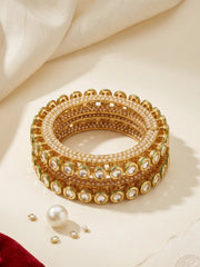 Gold plated pearl and Kundan Pacheli bangles with green Meenakari accents, styled with traditional sarees, lehengas and ethnic outfits.