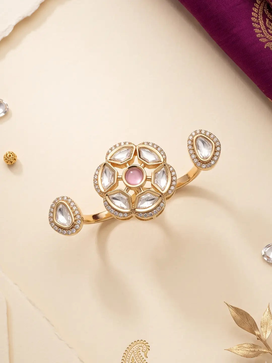 Gold plated pink dual finger Polki statement ring with three connected focal elements, Kundan detailing and a bold floral-inspired design for ethnic wear