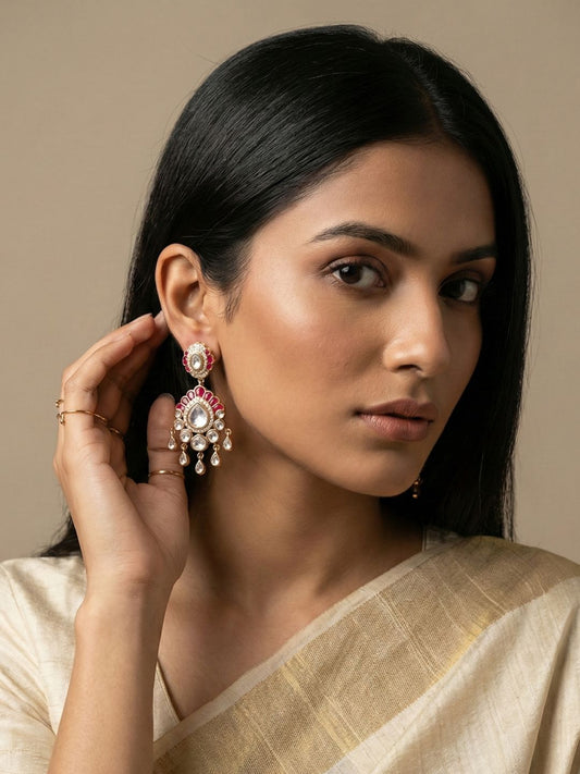 Ruby Pink Kundan Polki dangler earrings featuring brilliant-cut stones, ruby accents and layered droplet detailing for weddings and festive occasions.