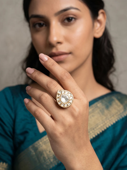 Gold plated teardrop Polki Kundan ring featuring a luminous pear-shaped centre stone, delicate halo accents and an elongated silhouette for festive wear