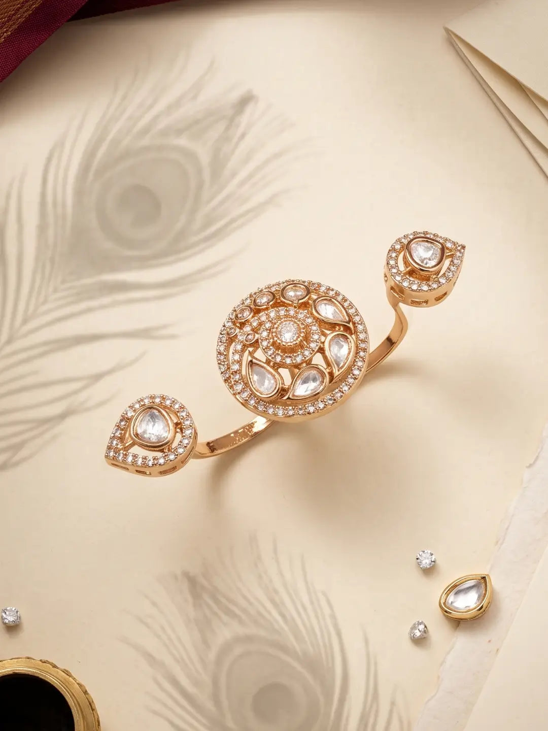 Gold plated white dual finger Polki ring with three connected focal elements, intricate Kundan detailing and a statement silhouette for festive outfits
