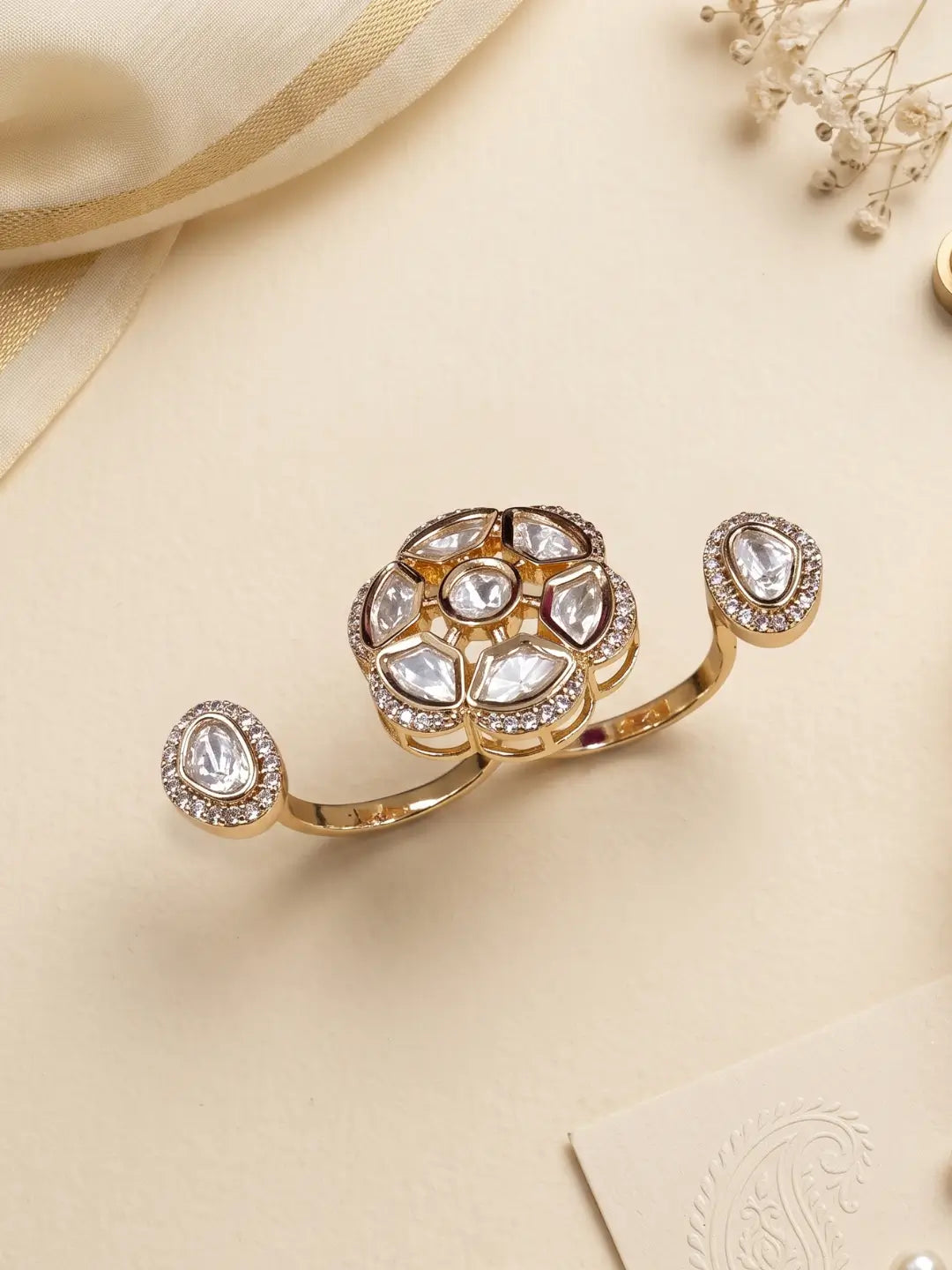 Gold plated white dual finger Polki ring with three connected focal elements, intricate Kundan detailing and a bold design for sarees and lehengas