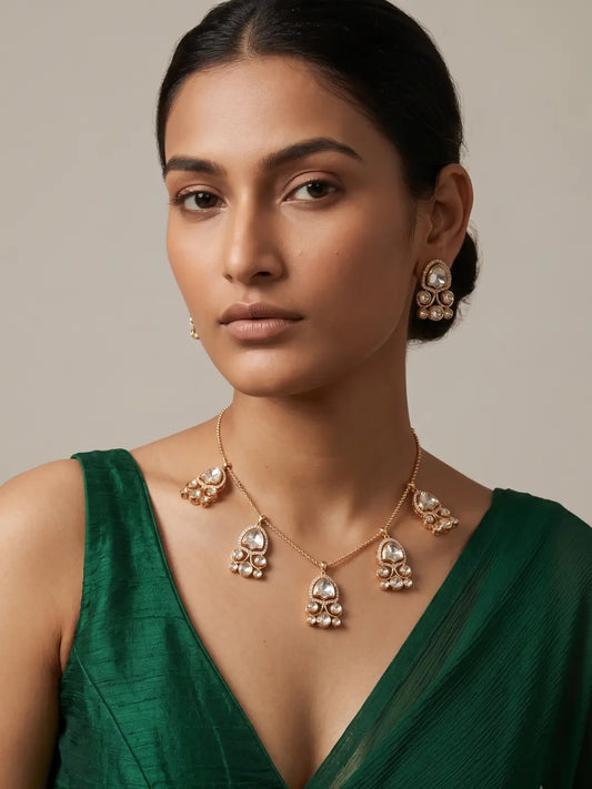 Gold plated chain necklace with floral Polki drops and matching stud earrings, designed for elegant festive and occasion styling.