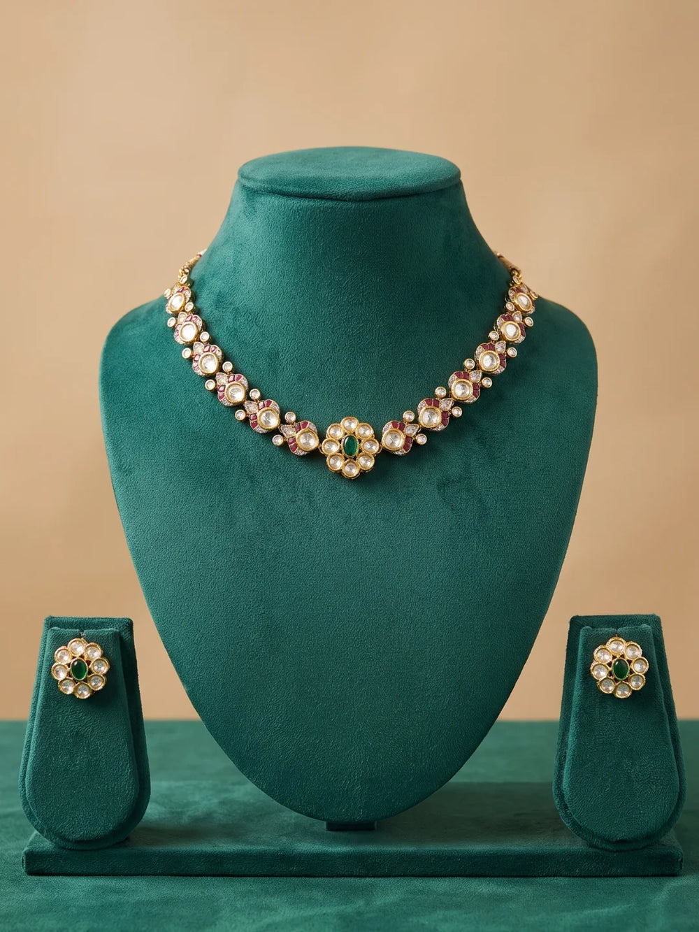 Green dual-tone necklace with Polki and CZ stones, floral enamel motifs, coloured accents and matching earrings.
