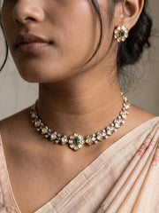 Green dual-tone Polki necklace set with a floral centrepiece, enamel detailing, clear CZ stones and matching stud earrings.