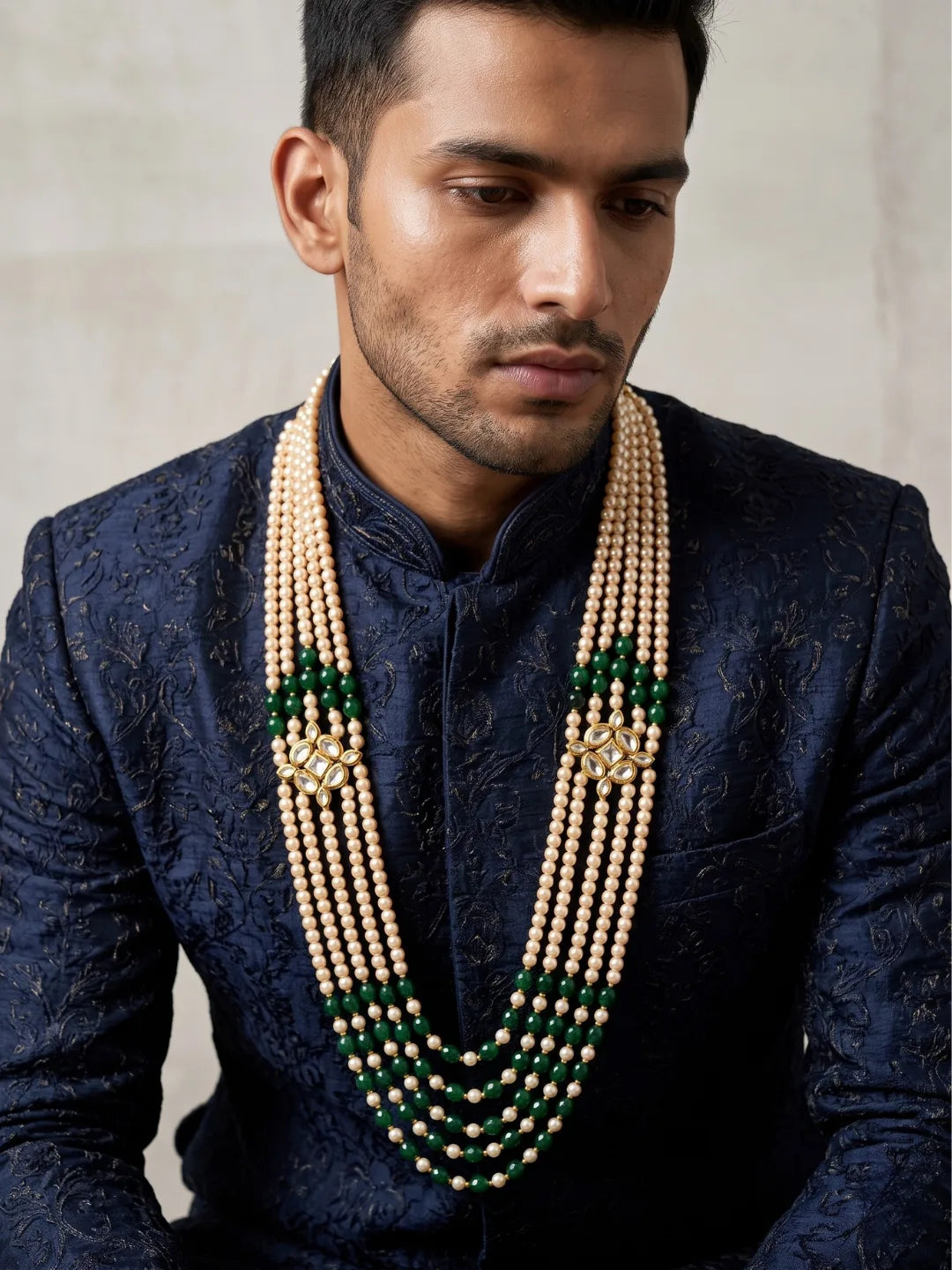 Traditional green dulha mala with cascading jade beads, faux pearls and ornate Kundan-style brooches for coordinating with wedding attire.