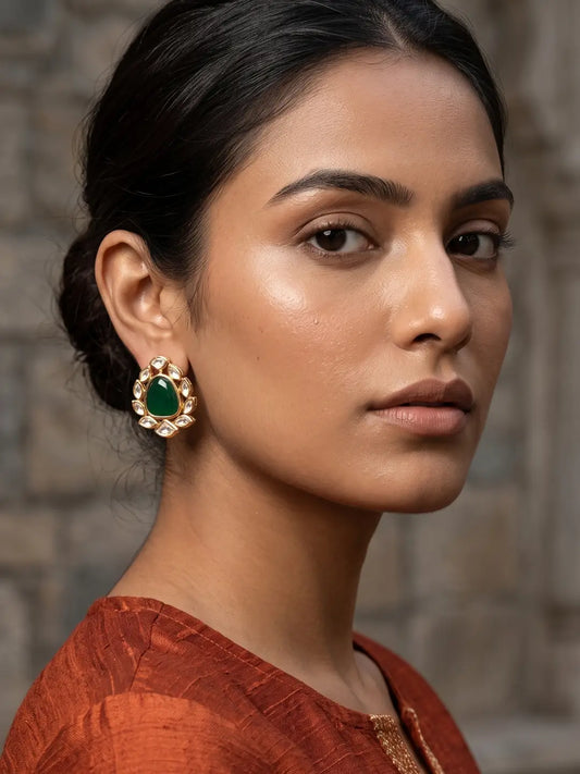 Gold plated green Polki earrings featuring emerald and ruby stones in a floral-inspired pattern with sparkling white accents