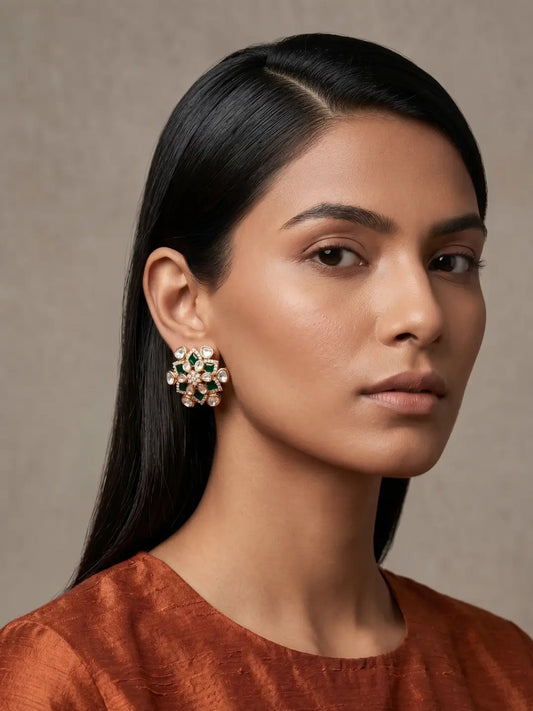 Green floral Kundan stud earrings featuring clear petal stones, green enamel accents and a sparkling central stone