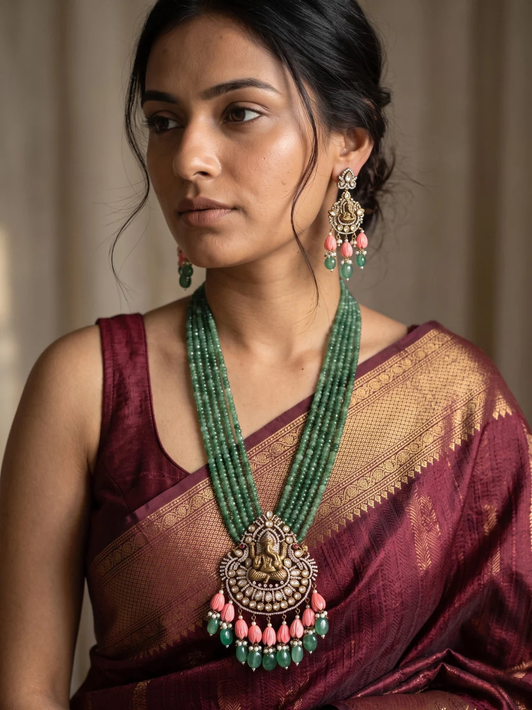 Green Ganesha temple necklace set featuring an ornate Ganpati pendant, antique-style detailing, layered jade beads and matching traditional earrings.
