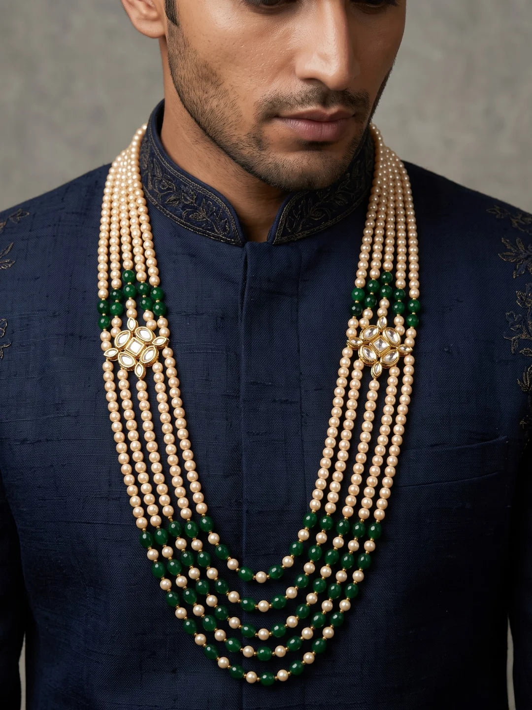 Green groom sherwani mala featuring layered jade bead strands, faux pearls and decorative gold-plated Kundan-style side brooches.