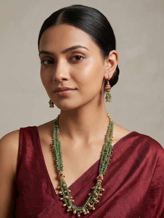 Green jade bead necklace and earrings set with gold-tone detailing and pink stone accents, suited to mehndi, sangeet and festive outfits