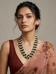 Triple-layer mala necklace with alternating green jade beads and faux pearl beads in graduated strands and gold-plated detailing