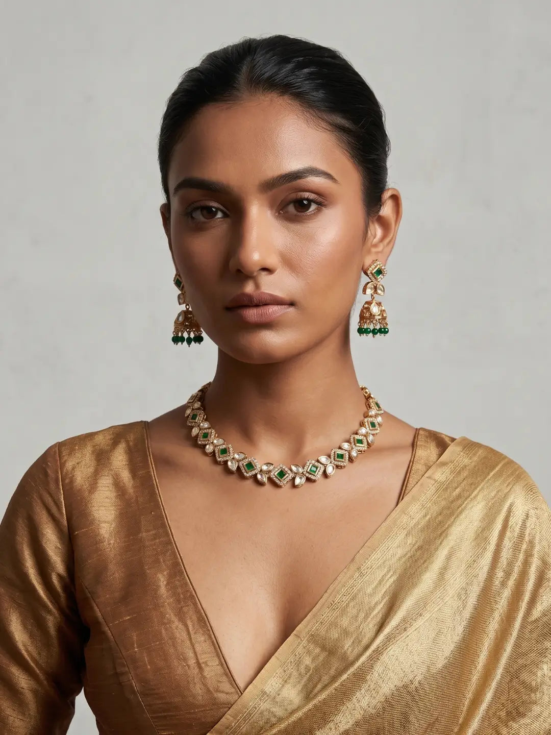Green Kundan choker necklace with Jhumka earrings, emerald-green square-cut stones and white Polki detailing