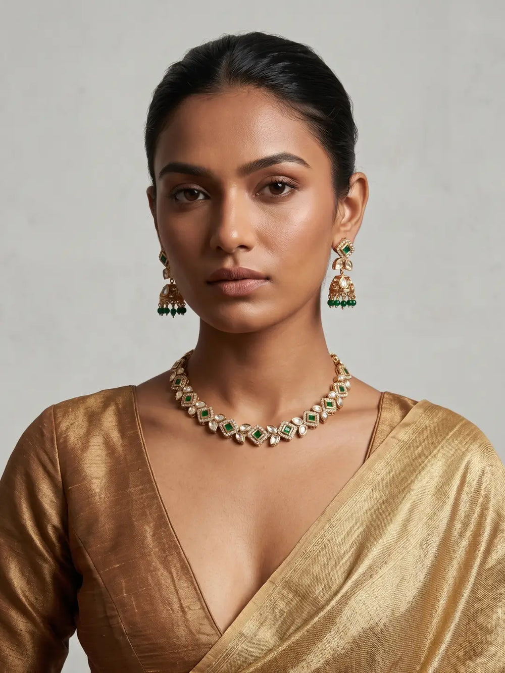 Green Kundan choker necklace with Jhumka earrings, emerald-green square-cut stones and white Polki detailing