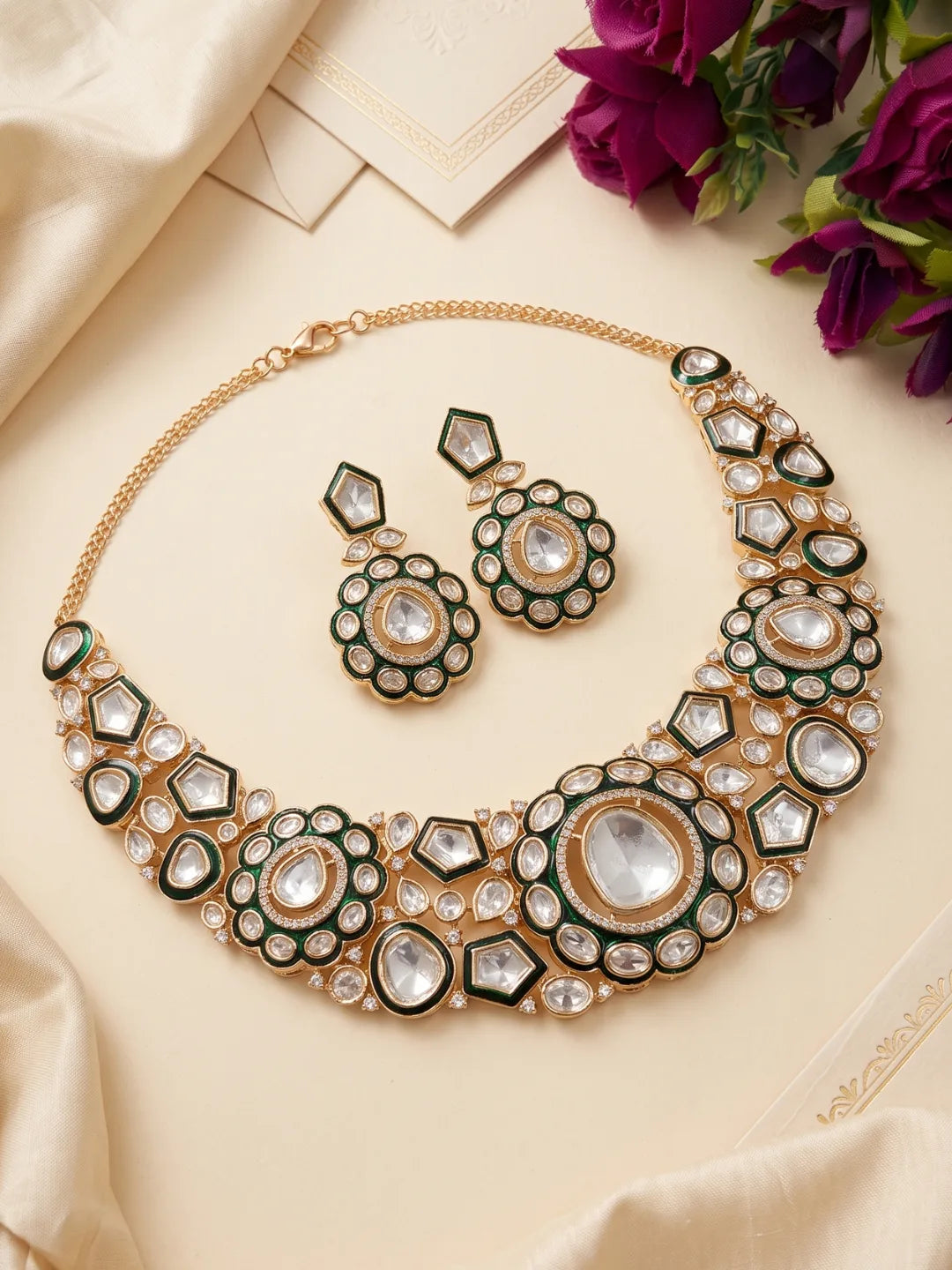 Traditional green necklace featuring Kundan and Polki-style stone detailing, a decorative central design and matching statement earrings.