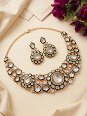 Traditional green necklace featuring Kundan and Polki-style stone detailing, a decorative central design and matching statement earrings.