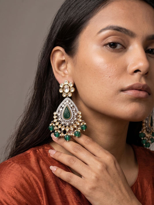 Green dual tone Kundan Chandbali earrings featuring carved natural teardrop stones, Polki-inspired detailing and delicate pearl hangings.