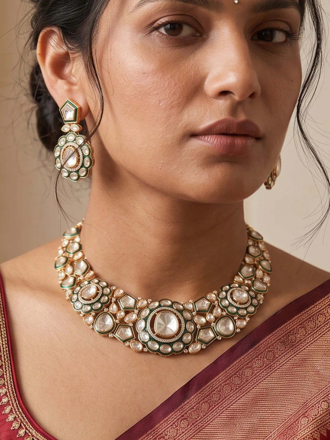 Green Kundan Polki necklace set featuring intricate stonework, green accents, antique gold-tone detailing and matching drop earrings.