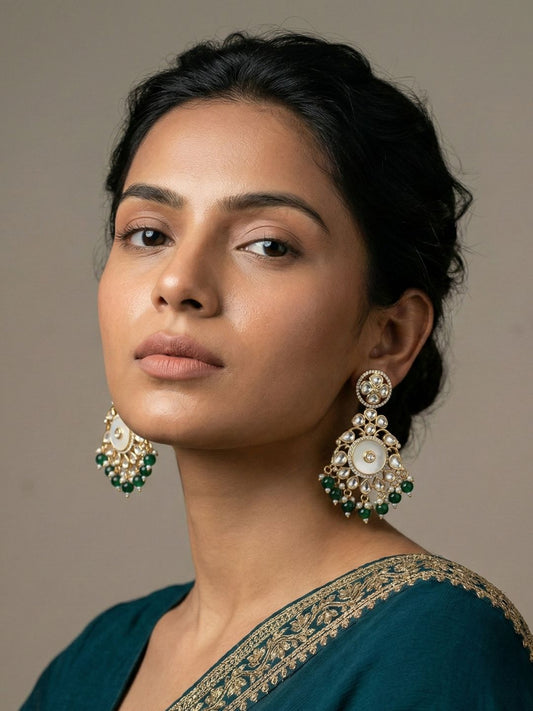 Green gold plated Chandbali earrings with a circular mother of pearl centre, teardrop Kundan stones, crystal detailing and pearl drops.