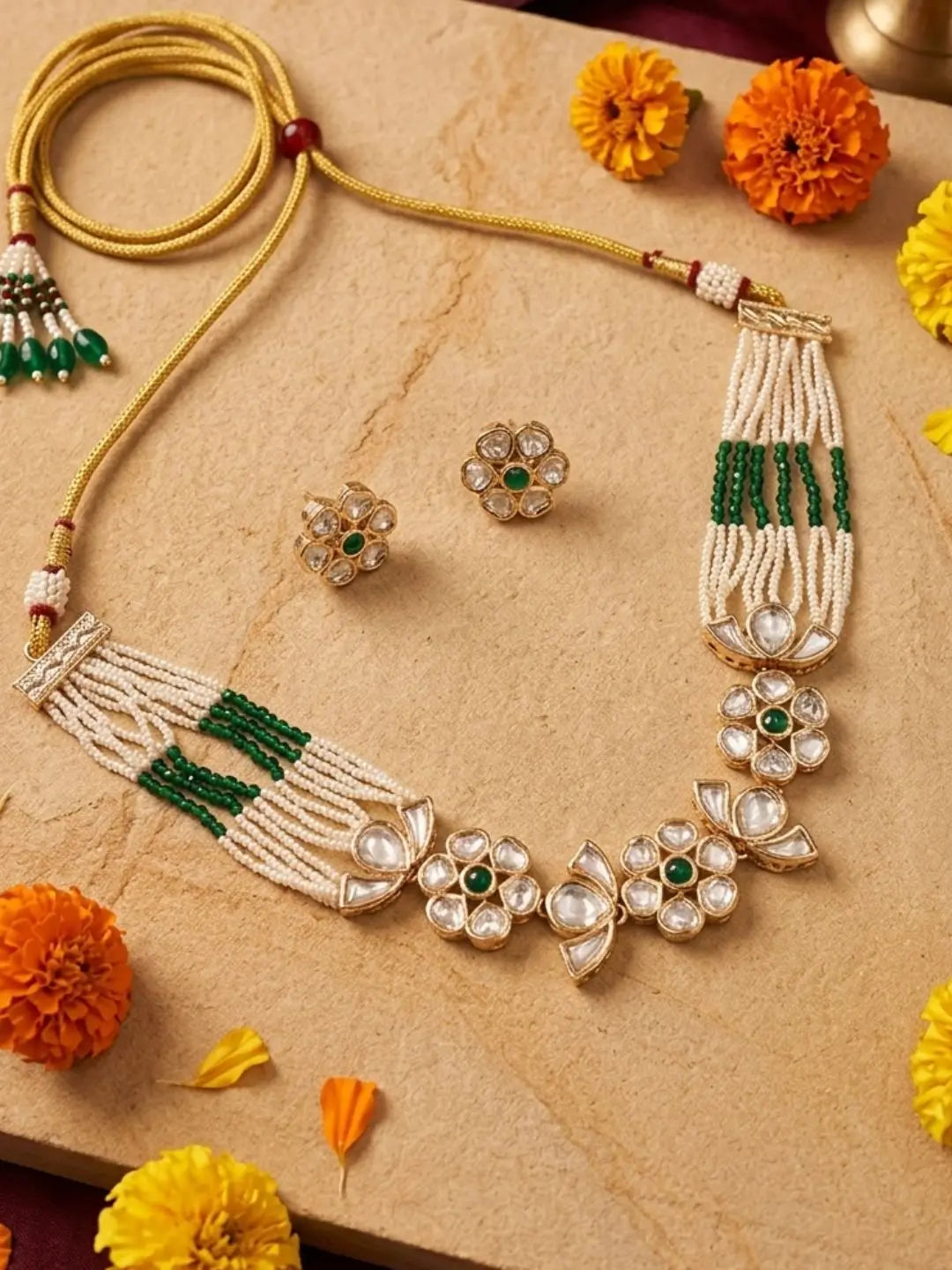 lose view of the green delicate pearl choker showing floral kundan motifs, polki stones and fine multi-strand pearl beading