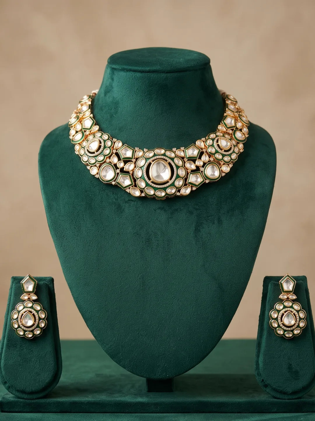 Green-accented Kundan Polki necklace with gold-plated detailing and matching drop earrings, designed to complement sarees and lehengas.