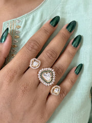 Green Polki dual finger ring with two connected gold-tone bands, Kundan stonework, emerald accents and sparkling CZ details for bridal festive styling