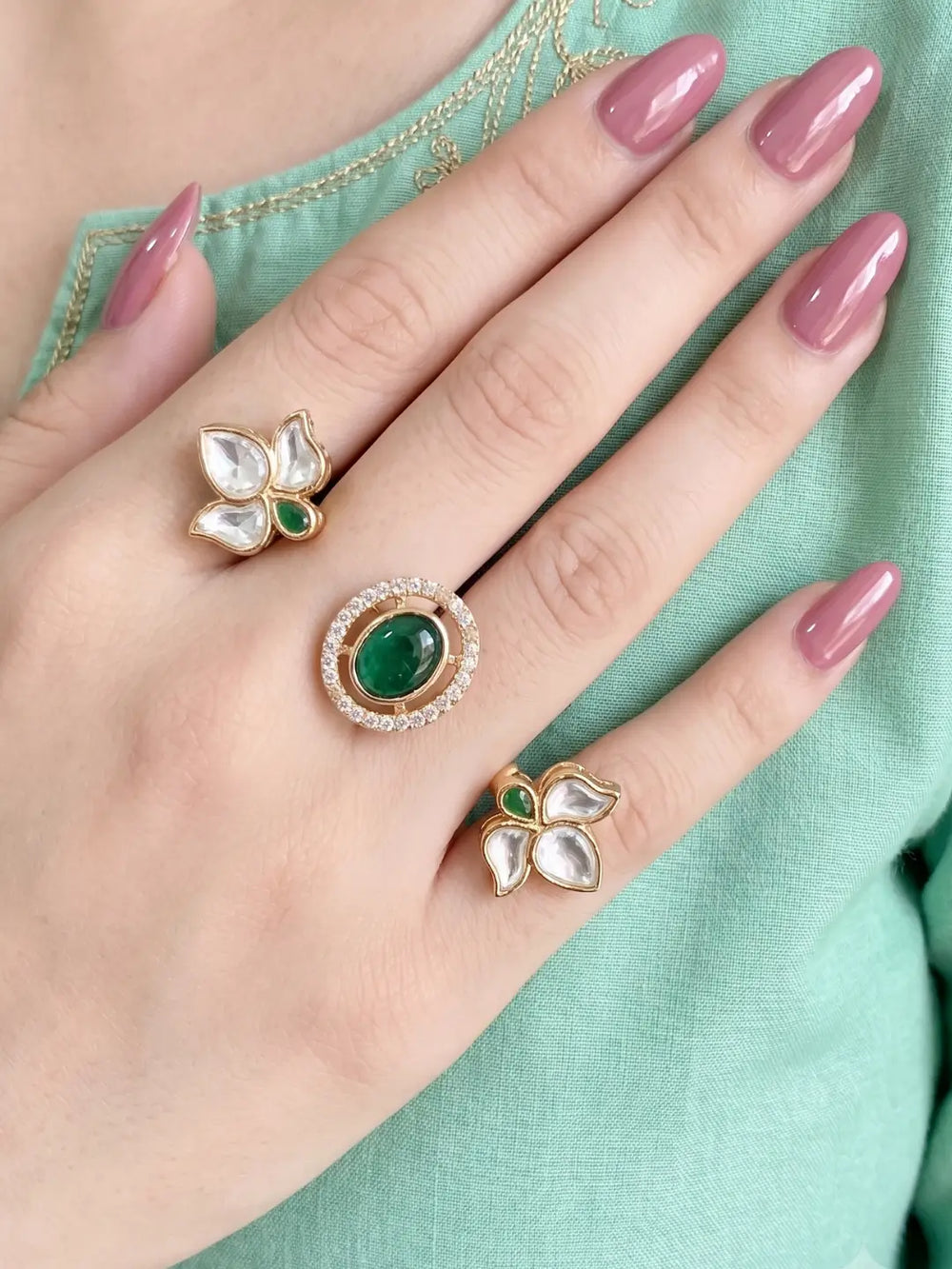 Green Polki Kundan dual finger ring with two connected gold-tone bands, floral clusters, pear-shaped stones and a sparkling centre for festive looks