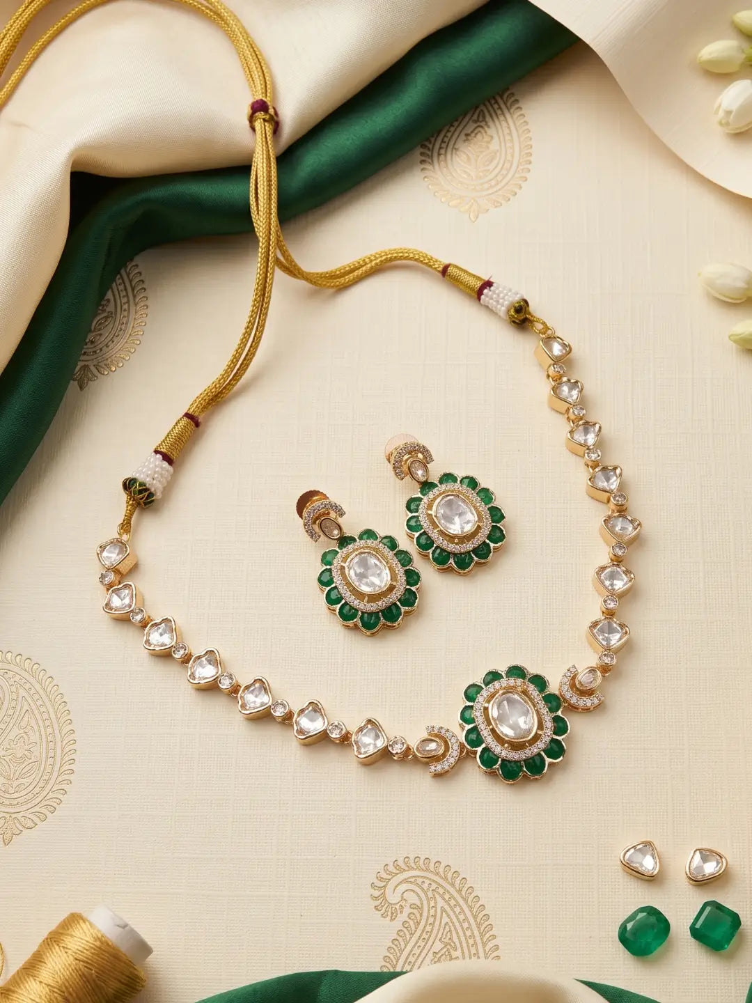 Green Polki Kundan statement choker set featuring CZ stones, enamel detailing and matching earrings, styled with traditional Indian outfits.
