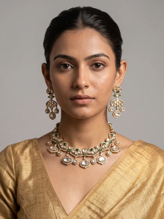 Green polki necklace set with Kundan-style earrings, synthetic emerald accents and gold-plated detailing for bridal wear