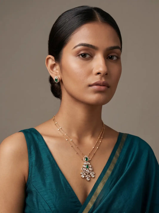 Gold-plated green Polki jewellery set with a delicate chain, teardrop pendant and matching stud earrings for festive, party and occasion wear