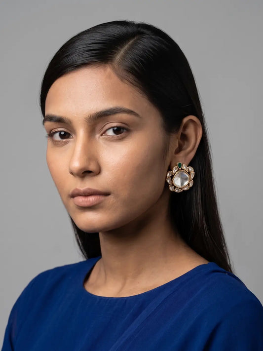 Oversized green Uncut Polki stud earrings with a rounded center stone, white petal accents and gold plated setting
