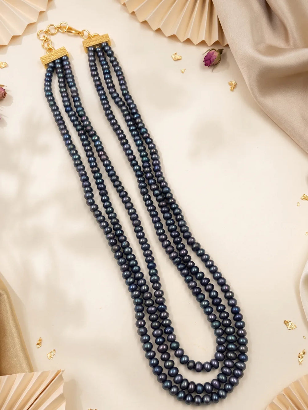Multi-strand black and grey pearl necklace shown with its adjustable closure, with the layered strands draping neatly around the neckline