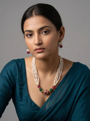 Layered freshwater pearl mala featuring ruby red and green jade watermelon-shaped beads with an ornate Kundan-style statement pendant.