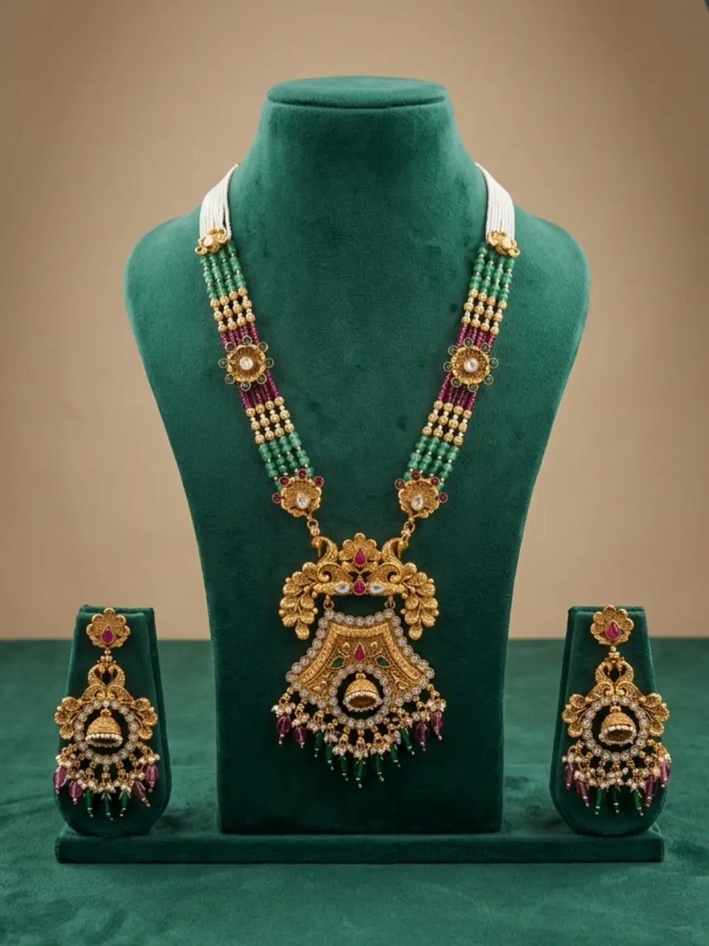 Detailed view of the necklace's traditional floral Kundan pendant with sparkling stones and dangling green and maroon beads.