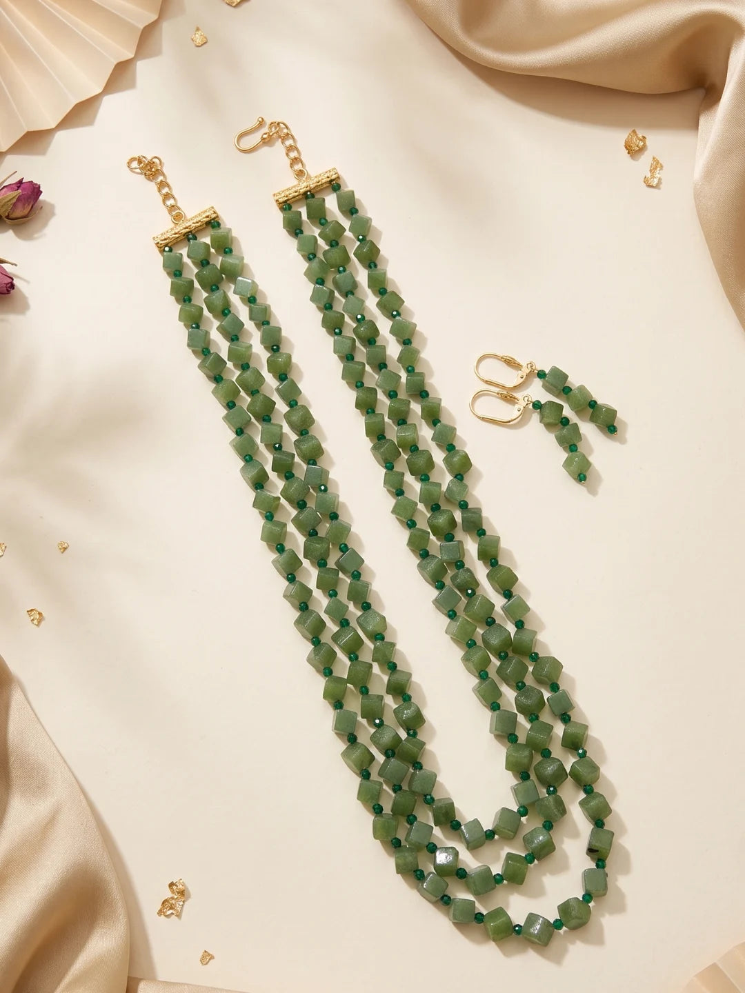 Layered olive green beaded necklace showing the adjustable hook-and-eye closure and the way the strands fall evenly around the neckline