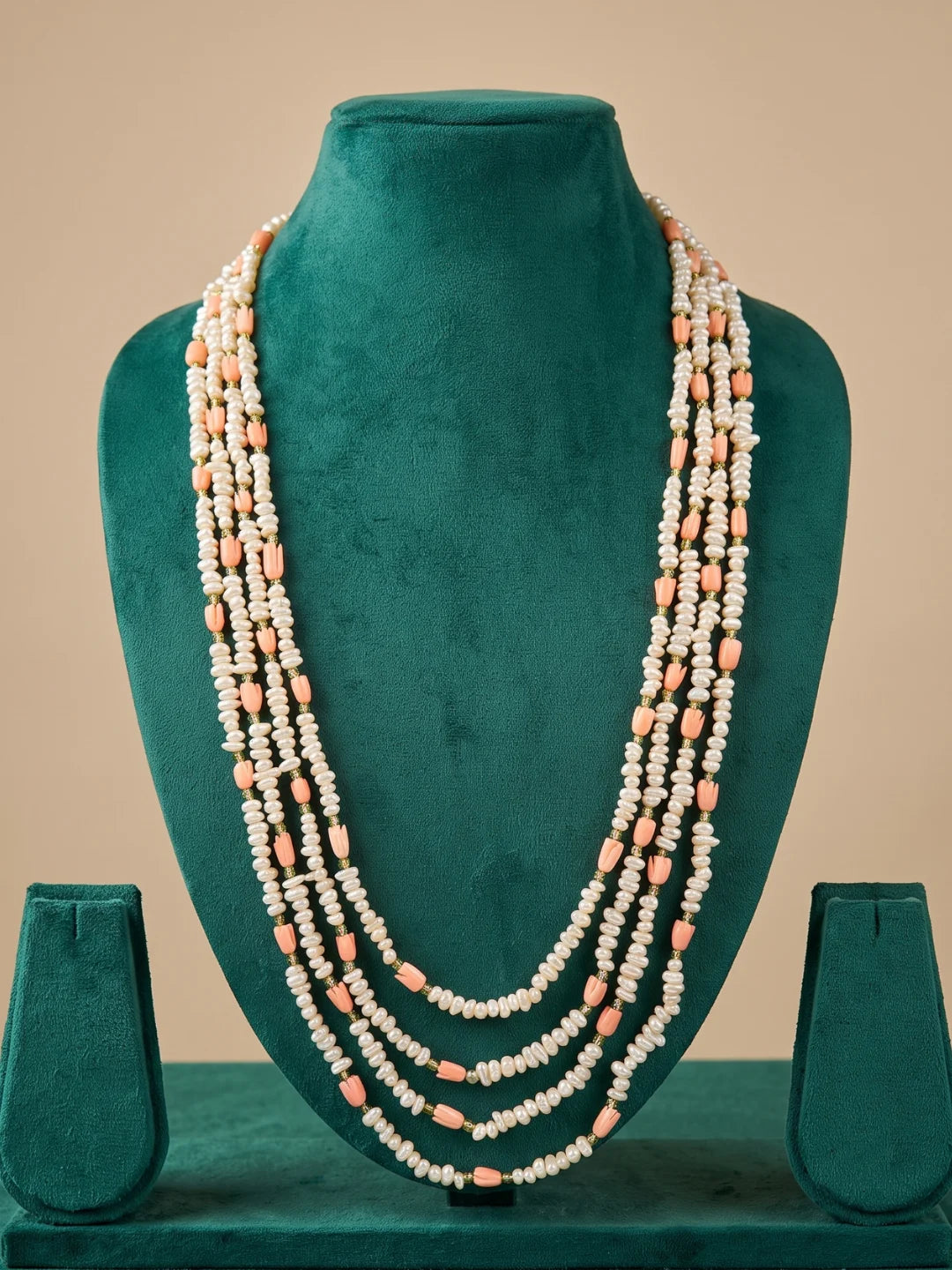 Layered freshwater pearl necklace styled with an ethnic outfit, showing how the cascading strands drape gracefully around the neckline
